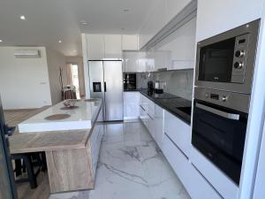 a kitchen with white appliances and a counter top at Castelo View in Pombal