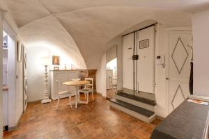 a hallway with a table and a door in a room at Florence Holiday Homes Ponte Vecchio in Florence