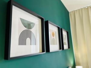 three framed pictures hanging on a wall at Le Dimore del Corso in Catania