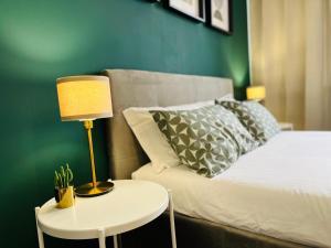 a bedroom with a bed and a table with a lamp at Le Dimore del Corso in Catania