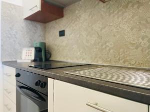 a kitchen with a stove and a counter top at Le Dimore del Corso in Catania