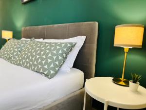 a bedroom with a bed and a table with a lamp at Le Dimore del Corso in Catania