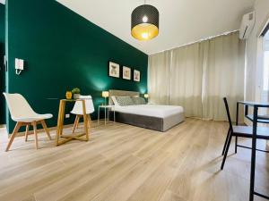 a bedroom with a bed and a green wall at Le Dimore del Corso in Catania