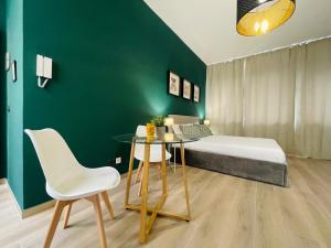 a bedroom with a bed and a table and chairs at Le Dimore del Corso in Catania