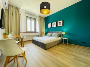 a bedroom with a bed and a blue wall at Le Dimore del Corso in Catania
