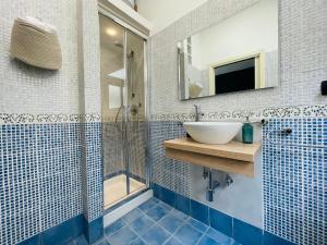 a bathroom with a sink and a shower at Le Dimore del Corso in Catania