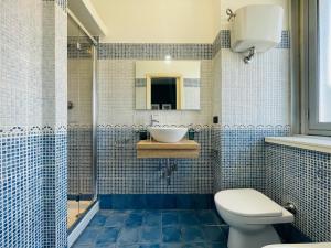 a bathroom with a toilet and a sink and a shower at Le Dimore del Corso in Catania