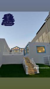 a house with a staircase in the front of it at منتجع مطل الريم in Taif +2 photos