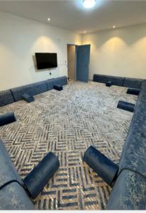 a large room with couches and a flat screen tv at منتجع مطل الريم in Taif