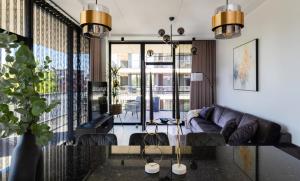 a living room with a couch and a table at Liine apartment 3027 in Pärnu