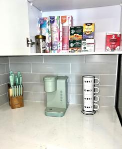 a kitchen counter with a blender on a shelf at Dreamy Pink Resort Style Oasis in Channelside in Tampa