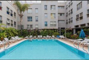 a swimming pool in front of a building at Buddha penthouse solarium+pool in Gáldar