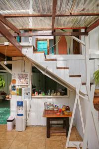 a kitchen with a staircase and a table in a house at Casa BOHÖ in Puerto Viejo