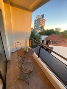a balcony with a table and chairs on a building at Dpto Temporario Corrientes in Corrientes