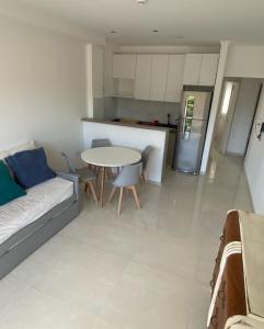 a living room with a couch and a table at Dpto Temporario Corrientes in Corrientes
