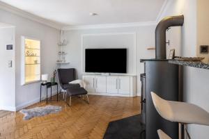 a living room with a flat screen tv on a wall at Ferienhaus Baumann in Quickborn