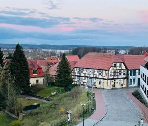 a group of buildings with red roofs and a street at Ferienwohnung Burgplatz 1 in Plau am See