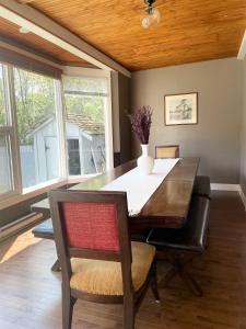 a dining room with a table with a vase on it at Three Peaks Banff in Banff