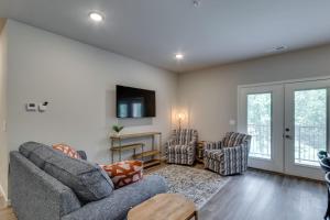 a living room with two chairs and a tv at NEW 3 BR Apartment Sleeps 6 in Pigeon Forge