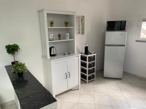 a kitchen with a white cabinet and a refrigerator at AriMAnd House in La Spezia