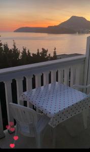 a polka dot table and chairs on a balcony with the ocean at Guest house Perović in Sutomore