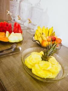 a table with a plate of fruit and a bowl of pineapple at Hotel Itatiaia in São Luís
