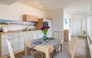 a kitchen with a table with a vase of flowers on it at Beautiful Apartment In Timmendorfer-strand With Wifi in Timmendorfer Strand