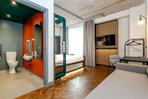 a hotel room with a bed and a bathroom at YOTEL Manchester Deansgate in Manchester