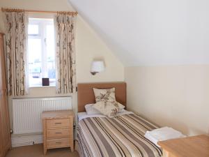 a small bedroom with a bed and a window at The Carlton in Rugby