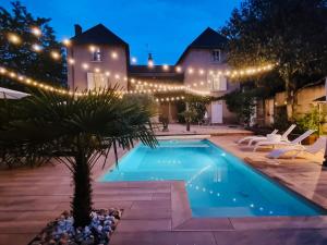 a swimming pool in front of a house with lights at CASA ALTEA in La Chapelle-de-Guinchay