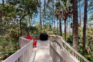 a wooden bridge with two chairs and a backpack on it at Sealoft 2032 in Hilton Head Island