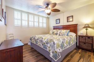 a bedroom with a bed and a ceiling fan at 106 Milowai in Wailuku