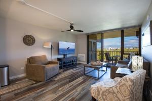 a living room with a couch and a flat screen tv at 4-309 Kamaole Sands**Newly Remodeled** Steps to Kamaole 3 Beach! in Wailea