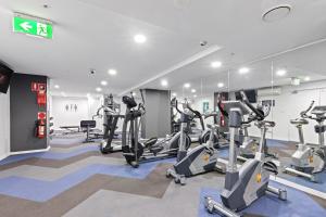 a gym with treadmills and ellipticals in a building at AAN Apartments North Sydney in Sydney