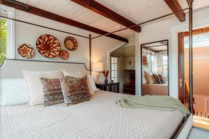 a bedroom with a large white bed with pillows at Swank House on Main St in Ashland in Ashland