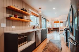 a kitchen with a sink and a counter top at Swank House on Main St in Ashland in Ashland +28 photos