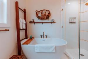 a bathroom with a white tub and a shower at Swank House on Main St in Ashland in Ashland