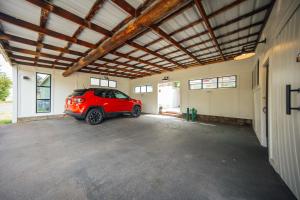 a garage with a red car parked in it at Swank House on Main St in Ashland in Ashland