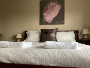 a bedroom with a bed with two pillows on it at Lexus House 10mins- Durham Uni & Heritage Coast 