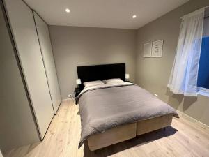 a bedroom with a bed and a large mirror at A place for Aurora in wintertime and midnight sun in summer-time! in Tromsø