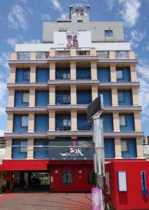 a tall building with a sign in front of it at HOTEL Iz bayside 大人専用 in Funabashi