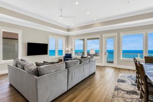 a living room with a large couch and a television at Macon Memories in St. George Island