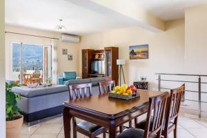 a living room with a table with fruit on it at Eleonora's in Skopelos Town +20 photos