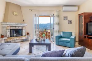 a living room with a couch and a fireplace at Eleonora's in Skopelos Town