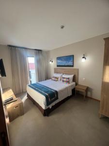 a bedroom with a large bed in a room at Resort Quinta Santa Bárbara in Pirenópolis +20 photos