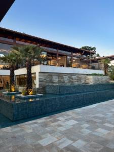 a building with two palm trees in front of it at Resort Quinta Santa Bárbara in Pirenópolis