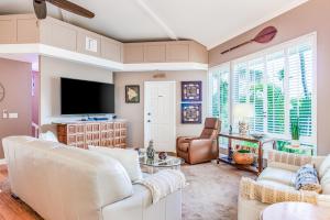 a living room with white furniture and a flat screen tv at Keauhou Paradise at Mauna Loa Village #10 in Kailua-Kona