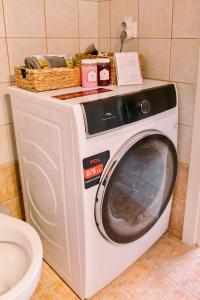 a washing machine with a basket on top of it at Morpheus Realm Apartment in Ioannina