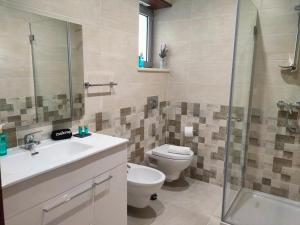 a bathroom with a toilet and a sink and a shower at Embaixada da Vila in Cascais +38 photos