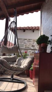 a porch with a rocking chair on a patio at Nikos Apartament in Prinos